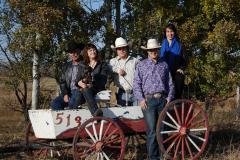 Photo of Dallas Foxwell and Family outside on wagon